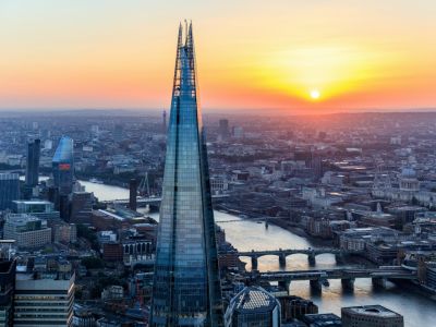 a view of the top of the shard at sunset against the london skyline