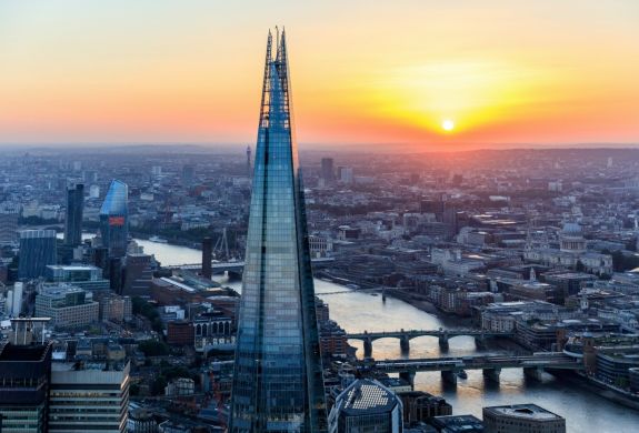 a view of the top of the shard at sunset against the london skyline