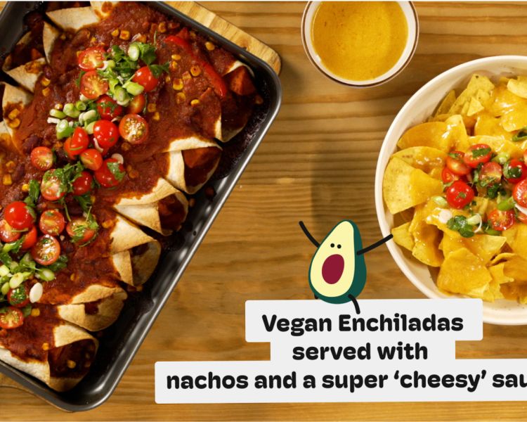 a meal of vegan enchiladas served with nachos and a cheesy sauce on a wooded table photographed from above