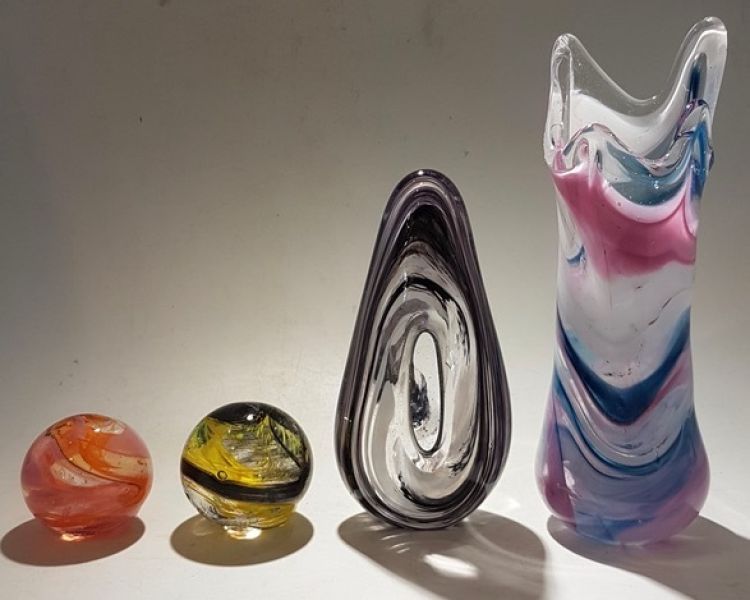 a selection of coloured glass objects made on a glassblowing experience