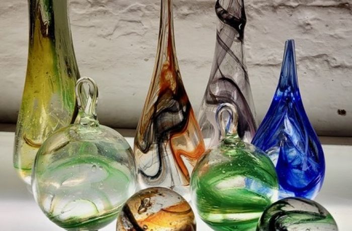 a collection of decorative coloured glass objects made on a glassblowing experience