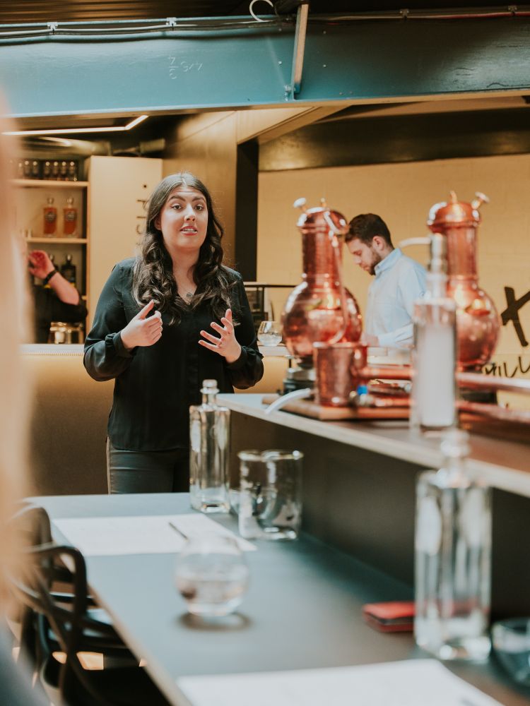 instructor talking to group on gin making experience in cheltenham