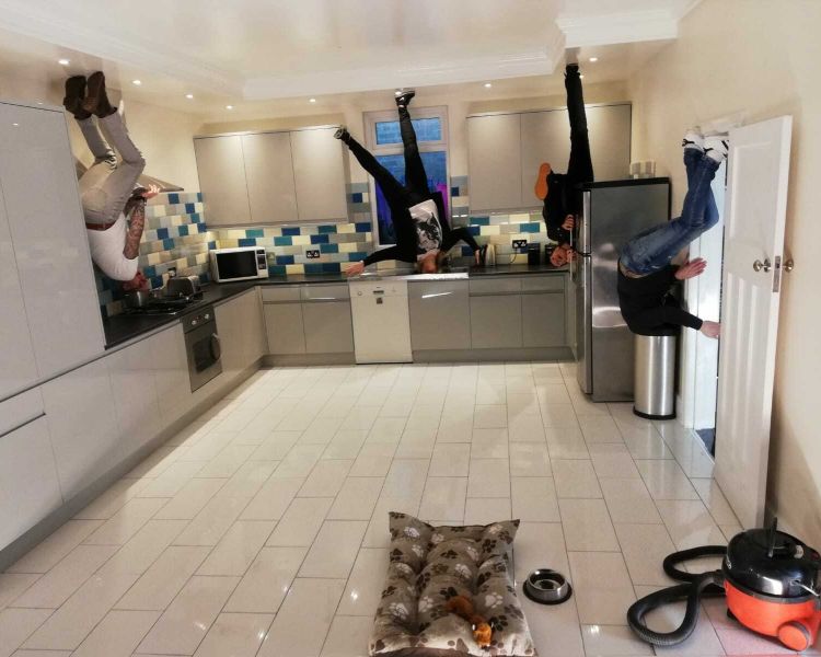 four people that look like they are walking upside down on the ceiling in a kitchen on a visit to the quirky quarter