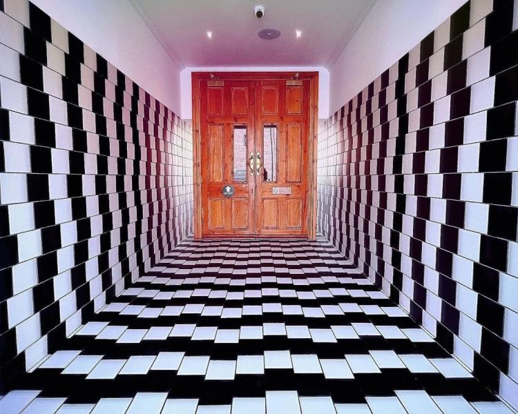 a tunnel walkway to a door that looks like it gets smaller seen at quirky quarter liverpool