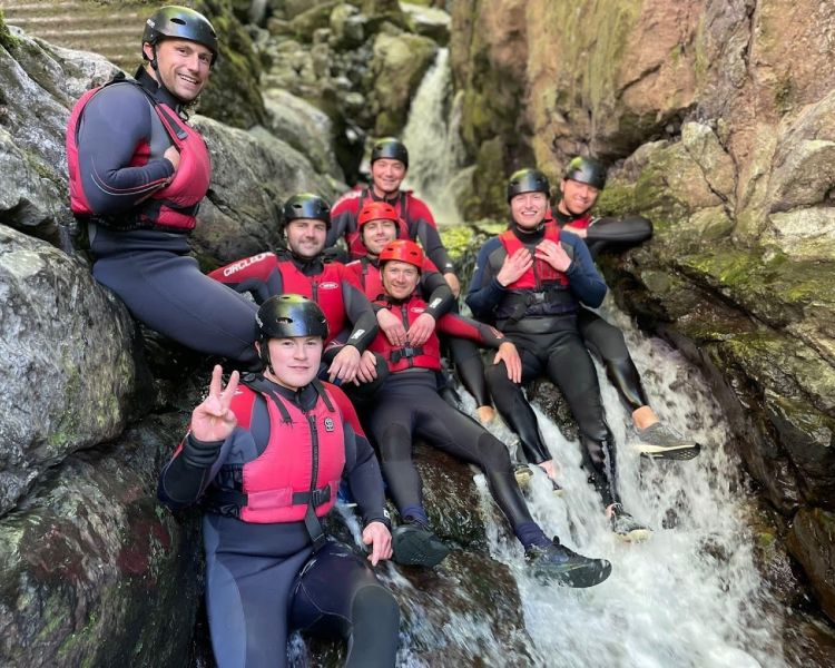 Group sat halfway down a waterfall