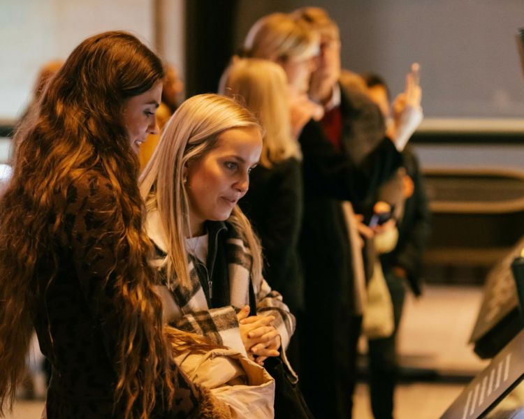 two women looking at the exhibits of the musuem at lift 109 at battersea power station in london