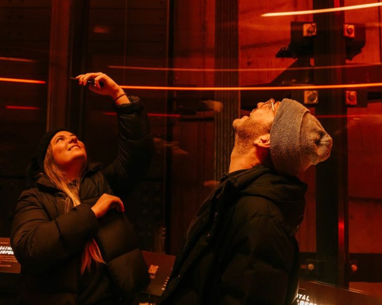 two people looking at the interactive exhibits at lift 109 at battersea power station in london