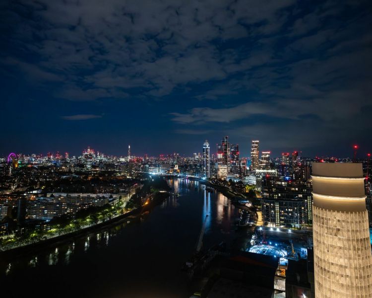 the london skyline at night seen from the top of lift 109 at battersea power station in london