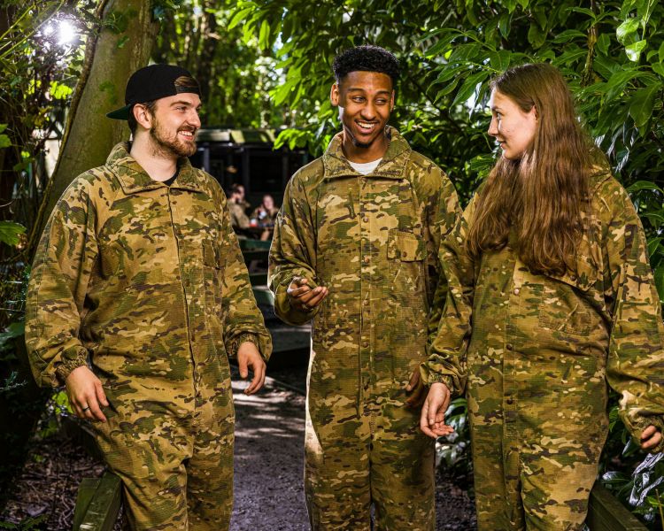 young people dressed in camouflage gear ready for paint balling