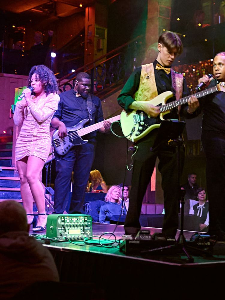 singers with a live band on stage at a motown dining experience in london
