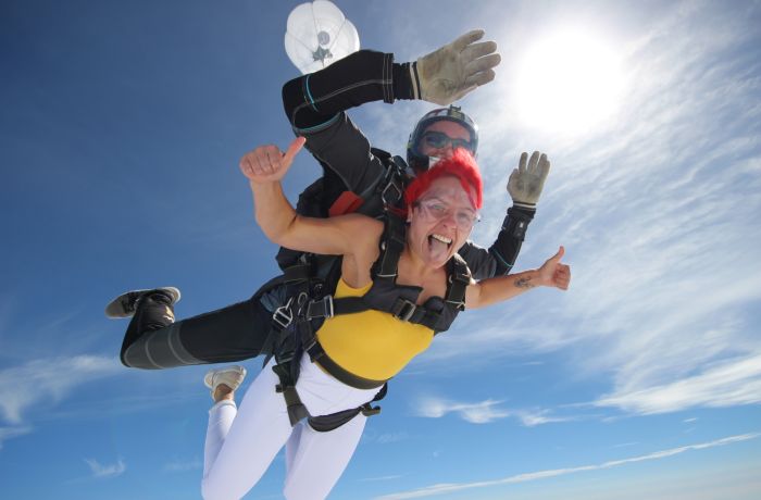 a woman on a tandem skydiving experience during freefall