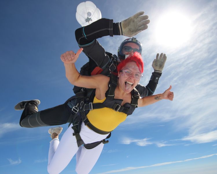 a woman on a tandem skydiving experience during freefall