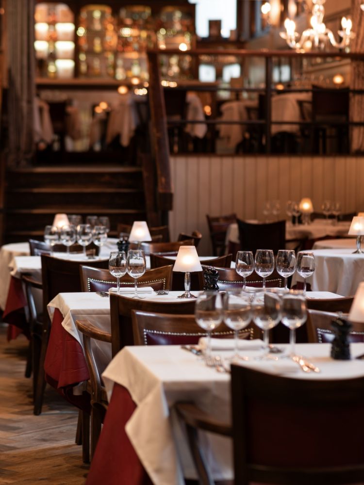 the dining area showing tables ready for diners at marco pierre white's london steakhouse company