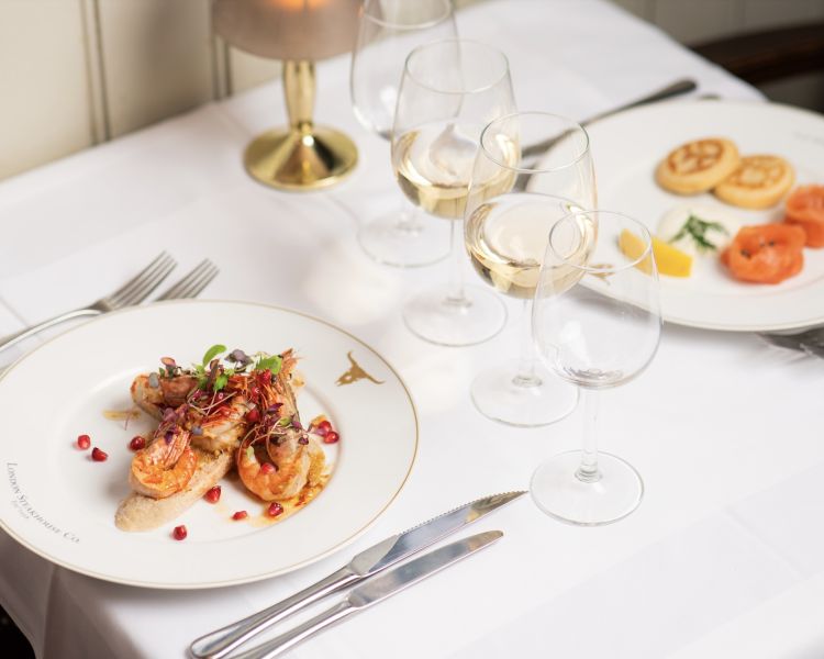 two meals laid out on a table for two at marco pierre white's london steakhouse company