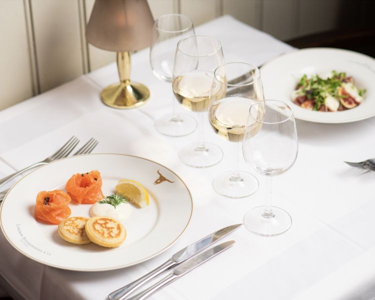 two meals at marco pierre white's london steakhouse company on a table for two