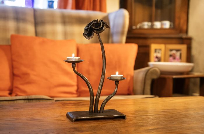 a cast iron rose tealight holder made on a blacksmith experience