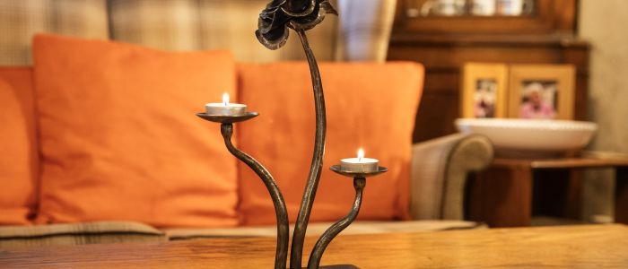 a cast iron rose tealight holder made on a blacksmith experience