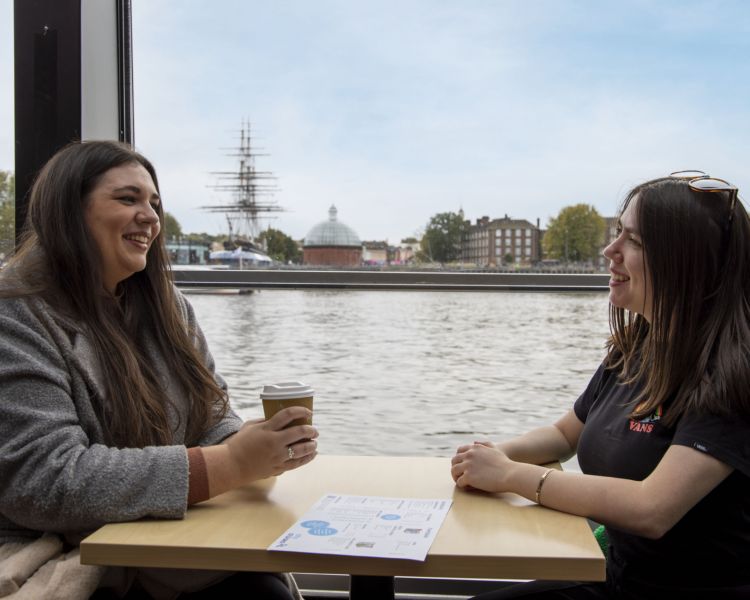 Two Guests Seated on the London Sightseeing River Cruise
