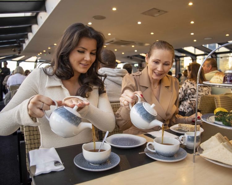 Guests Pouring Tea on the London Sightseeing River Cruise with Afternoon Tea