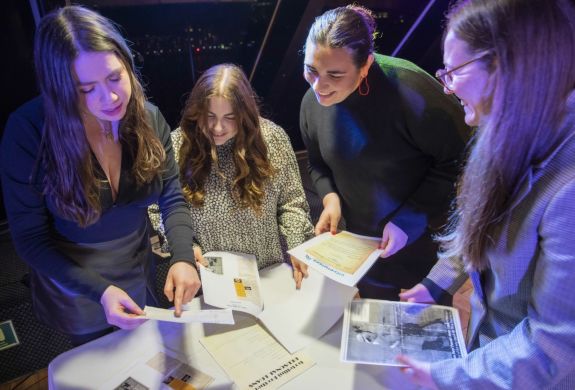 Girls Reading Clues on the Murder Mystery river cruise
