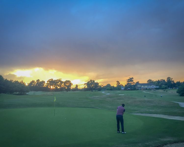 Golf course with sun setting