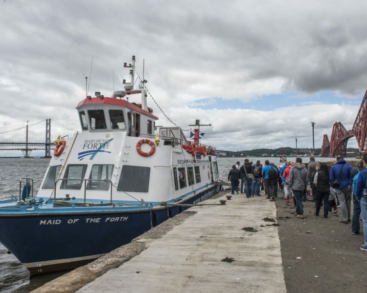 the maid of the forth cruise boat moored and ready to take passengers to inchcolm island as part of a daytime sightseeing cruise in scotland