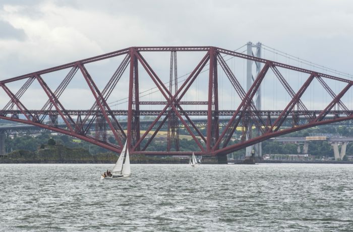 view of the forth bridges seen on a daytime sightseeing cruise in scotland