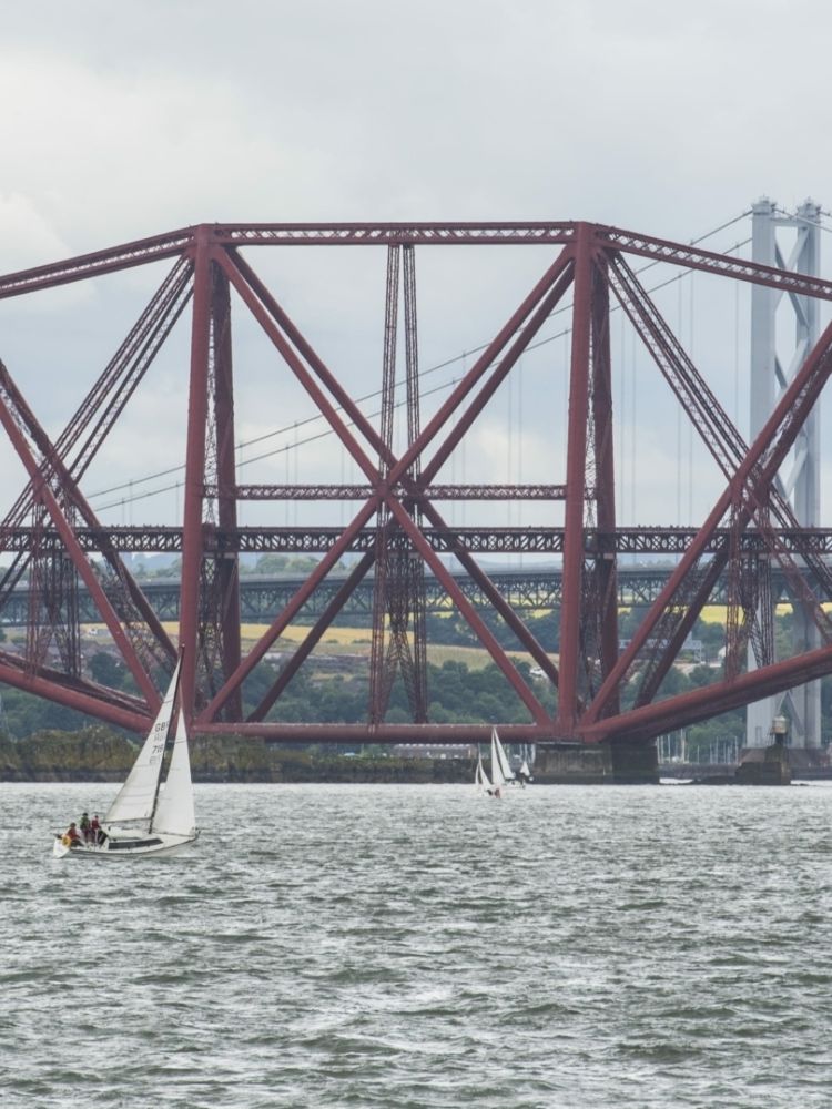 view of the forth bridges seen on a daytime sightseeing cruise in scotland