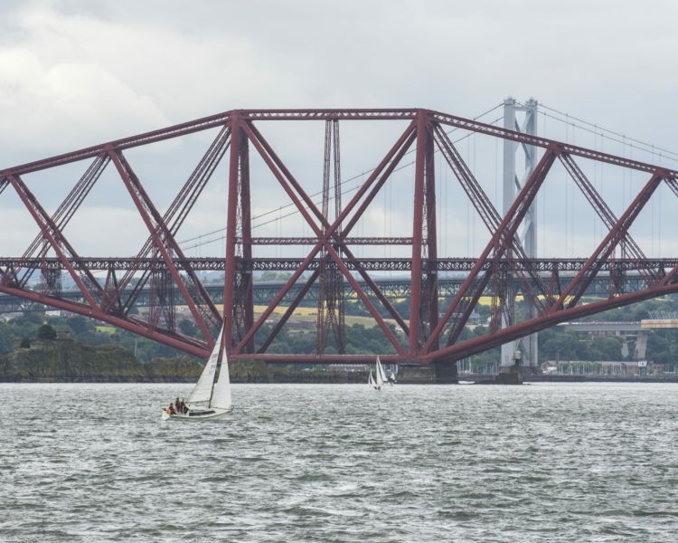 view of the forth bridges seen on a daytime sightseeing cruise in scotland