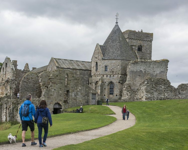 people visiting an old church on a daytime sightseeing cruise in scotland