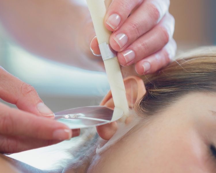 woman having a hopi ear candle treatment