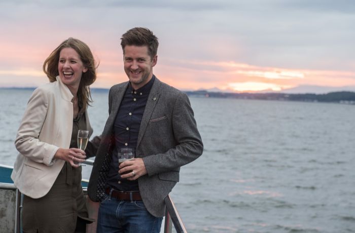 couple on the deck on a cruise boat on an evening themed sightseeing cruise in scotland