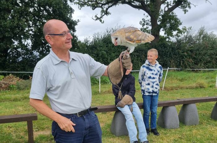 Man holding a barn owl