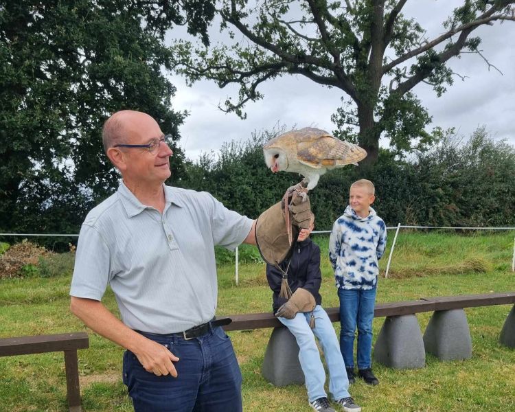Man holding a barn owl