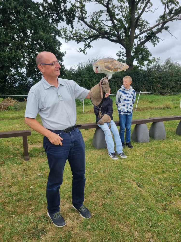 Man holding a barn owl