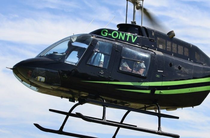a black and green helicopter in the sky as part of a helicopter ride for 1 nationwide
