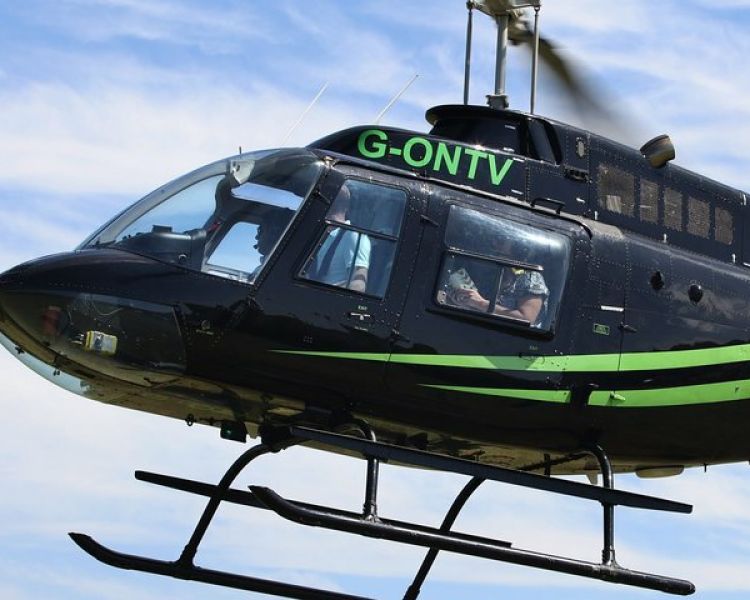 a black and green helicopter in the sky as part of a helicopter ride for 1 nationwide