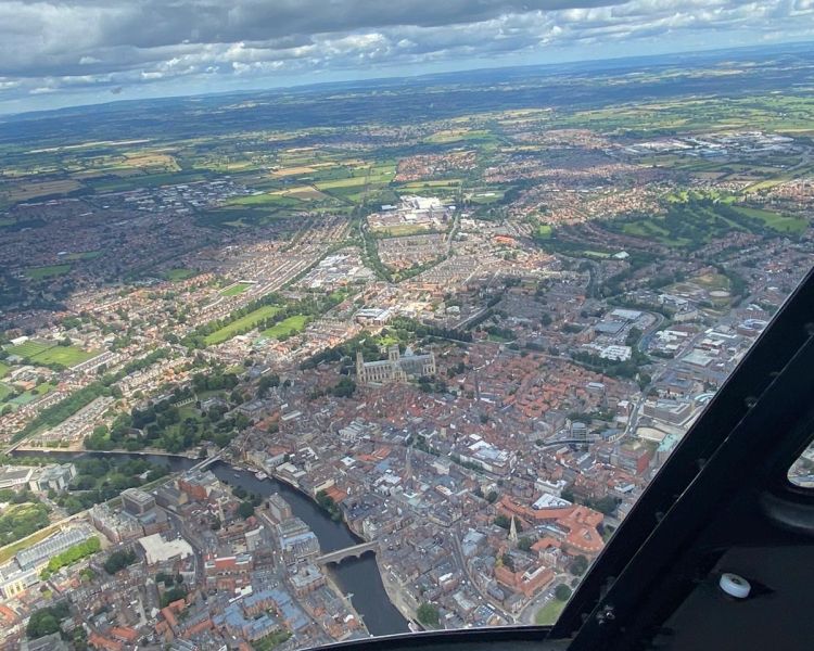 a photo of a countryside view taken during a helicopter flying experience