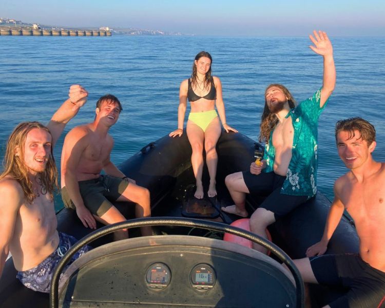 Group of people sat in a powerboat