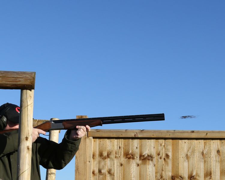 a man aiming a a gun taking part in a clay pigeon shooting experience available nationally