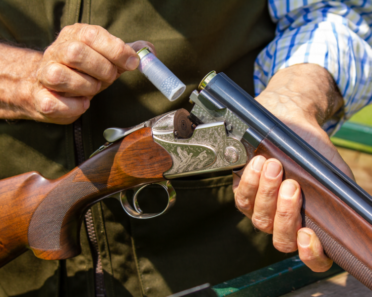 a man reloading a gun as part of a clay pigeon shooting experience available nationally