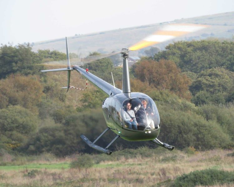 a tactical helicopter coming in to land as part of a helicopter lesson experience available nationwide