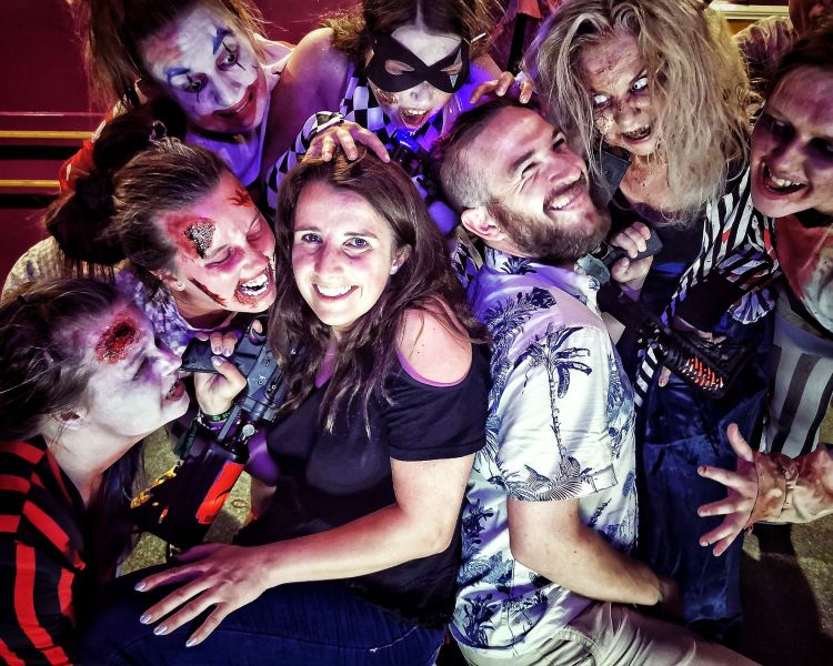 two people surrounded by zombies s part of a zombie birthday gift experience
