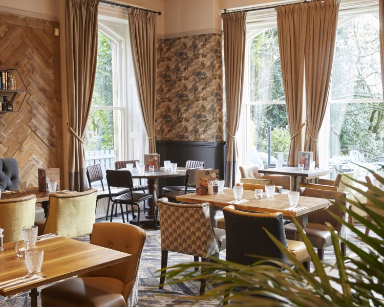 the inside of the holmfield arms showing a formal dining area decorated in a high end country style with neutral colours