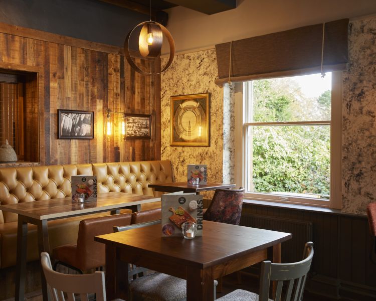 the inside of the holmfield arms showing the dining area decorated in a rustic country style