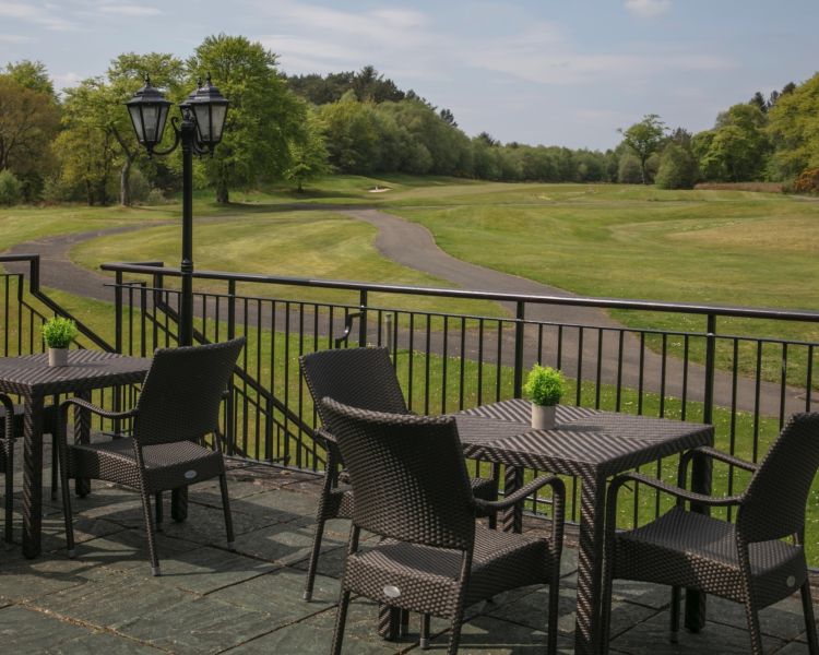 The outside terrace area with seating overlooking the golf course at the westerwood spa hotel in glasgow