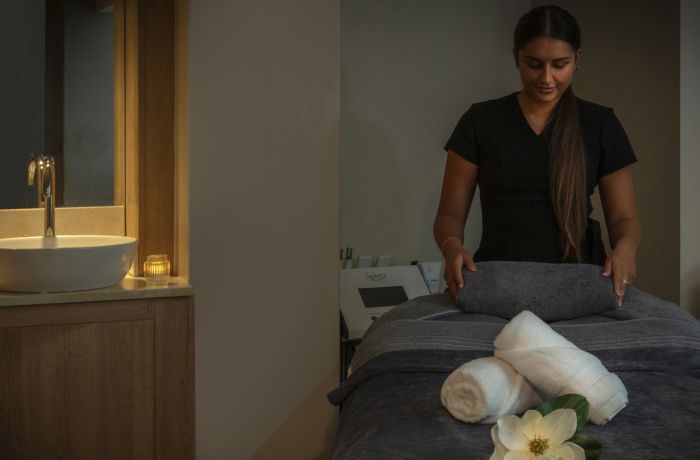 The spa therapist preparing the treatment room at the q hotels spa hotel in oxford