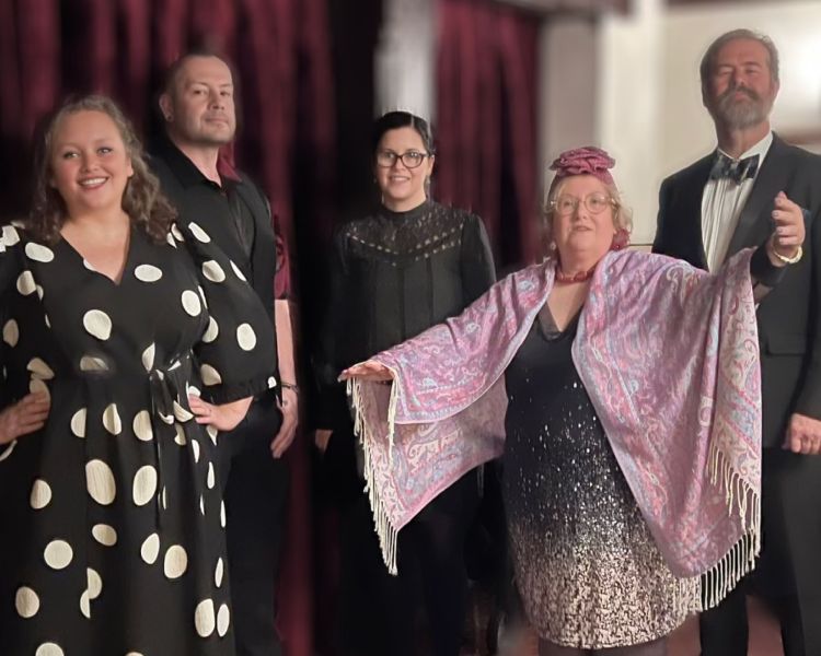 a group of actors dressed up smartly in fancy dress for a murder mystery dinner experience