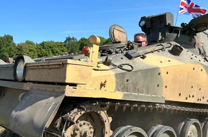a man driving a tank on tank driving experience