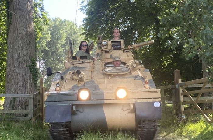 two people driving a tank on tank driving experience